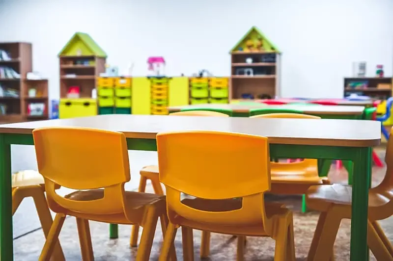 A clean and organized classroom with desks and a whiteboard