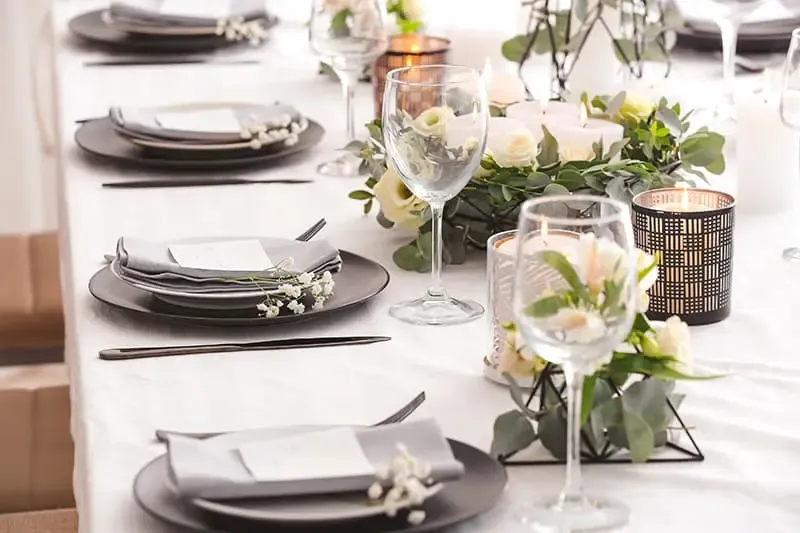 A clean event venue with tables and chairs arranged neatly