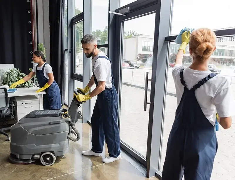 A team of people cleaning a commercial space